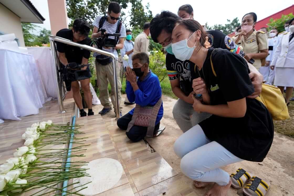 Relatives mourn during a ceremony for those killed in the attack on the Young Children's Development Center in Uthai Sawan, Thailand