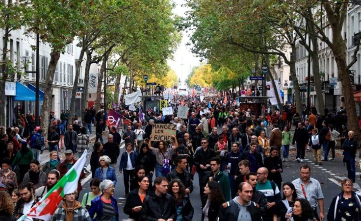 People gather for a march against the high cost of living and climate inaction in Paris, France