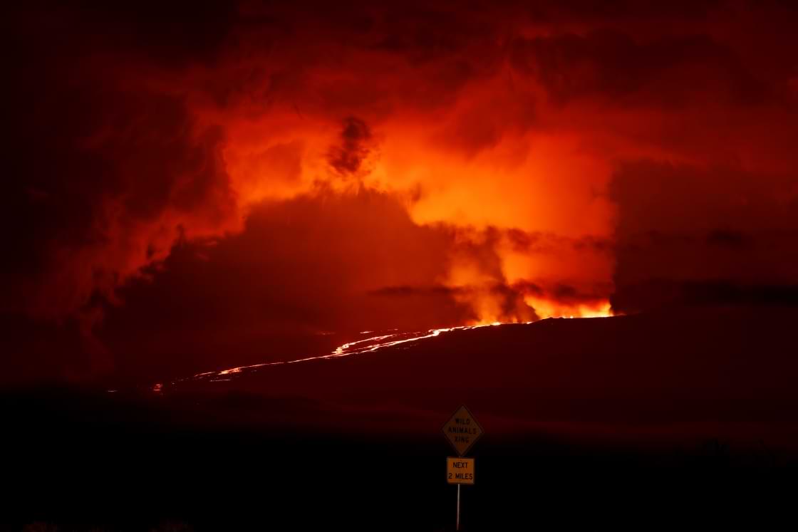 A river of lava flows down from Mauna Loa, Monday, Nov. 28, 2022, near Hilo, Hawaii. Mauna Loa, the world's largest active volcano erupted Monday for the first time in 38 years. (AP Photo/Marco Garcia)