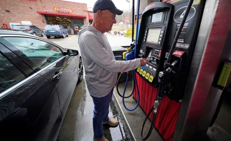 Darryl Matevish of Sewickley, Pa., fills his car with regular unleaded gas at $4.19.9 per gallon at a Sheetz store in Sewickley, Pa., Monday, March 7, 2022. For Thanksgiving 2022, the chain has lowered prices on Unleaded 88 to $1.99/gallon. (AP Photo/Gene J. Puskar)