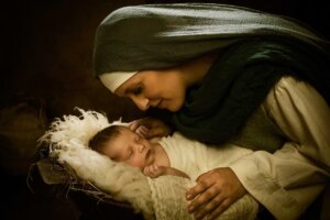 Mary hovers over newborn baby Jesus in a cotton-lined ancient crib. © By Anneke/stock.adobe.com