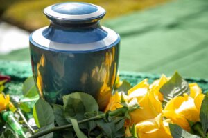 Urn for cremated ashes in a bed of flowers. What does the Bible say about cremation?