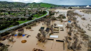 Floodwater covers a property along River Rd. in Monterey County, Calif., as the Salinas River overflows its banks on Friday, Jan. 13, 2023. (AP Photo/Noah Berger)