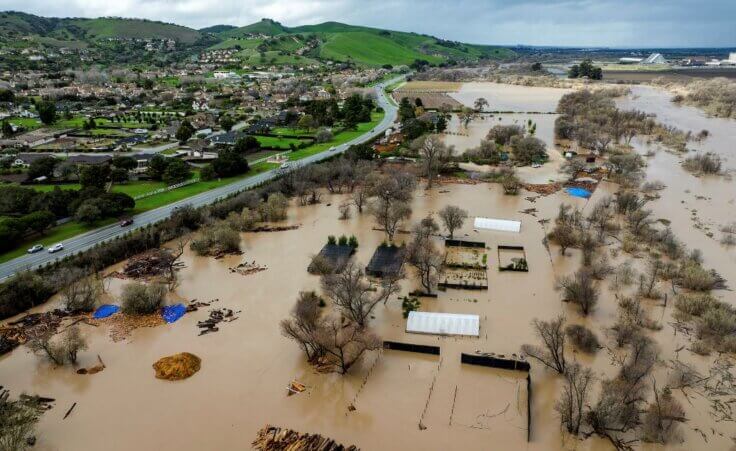 Floodwater covers a property along River Rd. in Monterey County, Calif., as the Salinas River overflows its banks on Friday, Jan. 13, 2023. (AP Photo/Noah Berger)