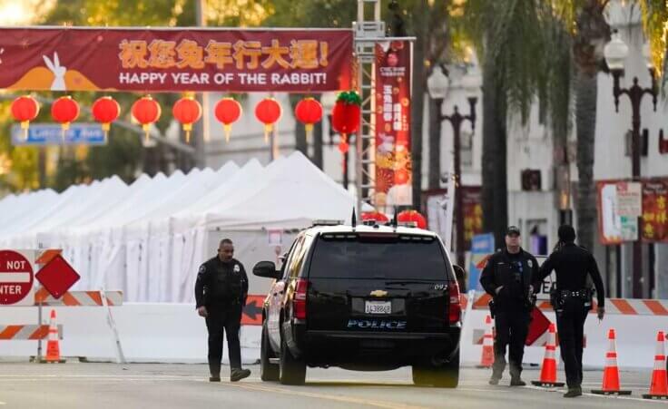 Police officers stand outside a ballroom dance club in Monterey Park, Calif., Sunday, Jan. 22, 2023. A mass shooting took place at a dance club following a Lunar New Year celebration, setting off a manhunt for the suspect. (AP Photo/Jae C. Hong)