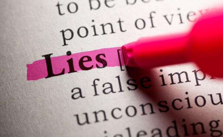 A pink highlighter highlights the word "lies" in a dictionary. © By Feng Yu/stock.adobe.com