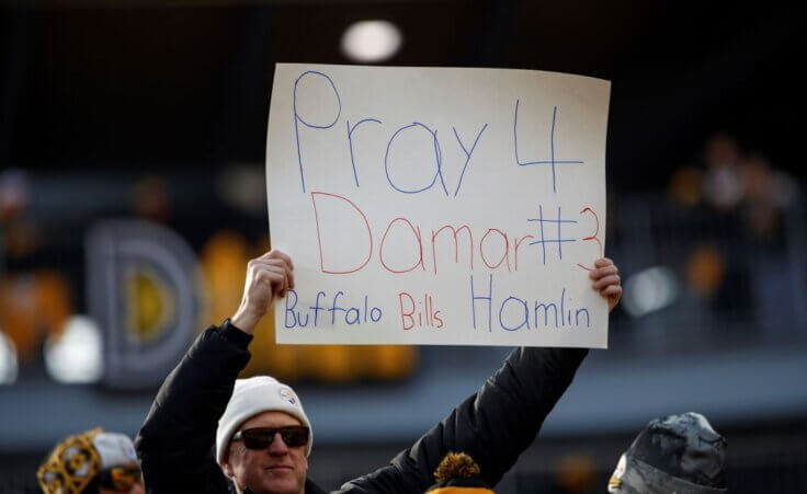 A fan holds a sign for Buffalo Bills safety Damar Hamlin before an NFL football game, Sunday, Jan. 8, 2023, in Pittsburgh, PA. (AP Photo/Matt Durisko)