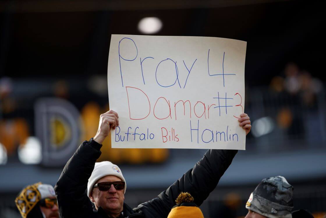 A fan holds a sign for Buffalo Bills safety Damar Hamlin before an NFL football game, Sunday, Jan. 8, 2023, in Pittsburgh, PA. (AP Photo/Matt Durisko)