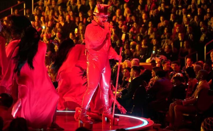 Sam Smith performs "Unholy" at the 65th annual Grammy Awards, dressed in red, wearing a top hat with horns.