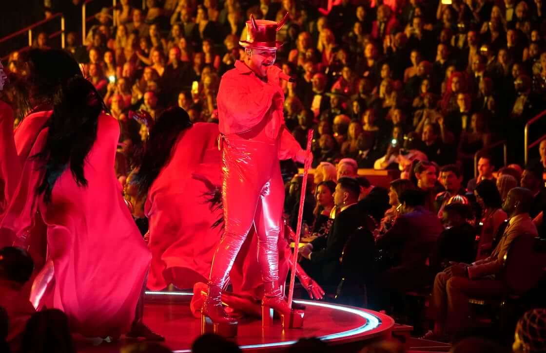 Sam Smith performs "Unholy" at the 65th annual Grammy Awards, dressed in red, wearing a top hat with horns.