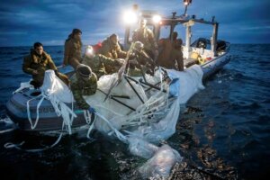 This image provided by the U.S. Navy shows sailors assigned to Explosive Ordnance Disposal Group 2 recovering a high-altitude surveillance balloon (one of China's spy balloons) off the coast of Myrtle Beach, S.C., Feb. 5, 2023. (U.S. Navy via AP)