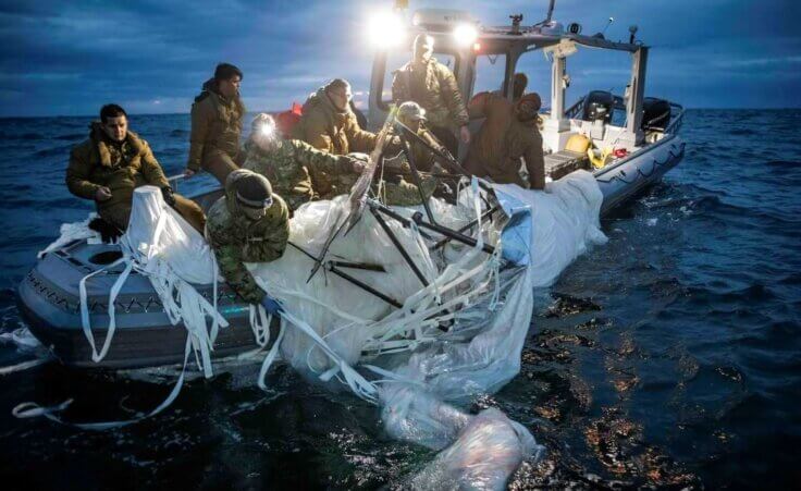 This image provided by the U.S. Navy shows sailors assigned to Explosive Ordnance Disposal Group 2 recovering a high-altitude surveillance balloon (one of China's spy balloons) off the coast of Myrtle Beach, S.C., Feb. 5, 2023. (U.S. Navy via AP)