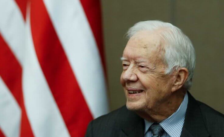 FILE - Former President Jimmy Carter smiles as he is awarded the Order of Manuel Amador Guerrero by Panamanian President Juan Carlos Varela during a ceremony at the Carter Center, Jan. 14, 2016, in Atlanta. Well-wishes and fond remembrances for the former president continued to roll in Sunday, Feb. 19, 2023, a day after he entered hospice care at his home in Georgia. (AP Photo/John Bazemore, File)