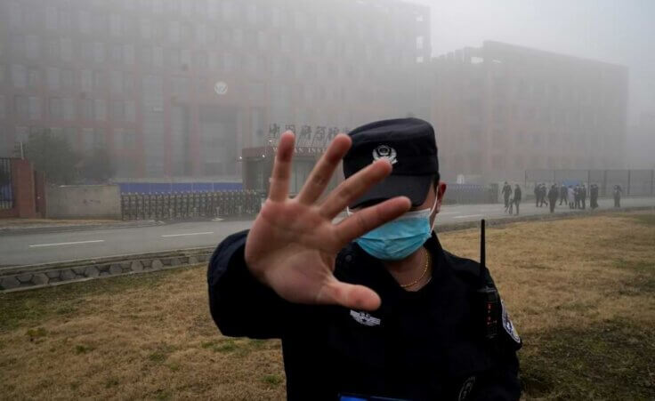 FILE - A security person moves journalists away from the Wuhan Institute of Virology after a World Health Organization team arrived for a field visit in Wuhan in China's Hubei province on Feb. 3, 2021. (AP Photo/Ng Han Guan, File). The US Energy Department has concluded that the COVID origin was most likely a lab leak.