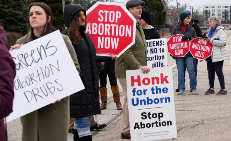 Anti-abortion groups protest near the Walgreens Deerfield headquarters over a plan to sell abortion pills in Deerfield, Ill., Tuesday, Feb. 14, 2023.