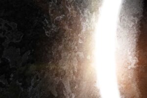 A close-up of a large stone rolling away from a tomb with a bright light shining from within. © By Balazs/stock.adobe.com | Did the resurrection of Jesus really happen?