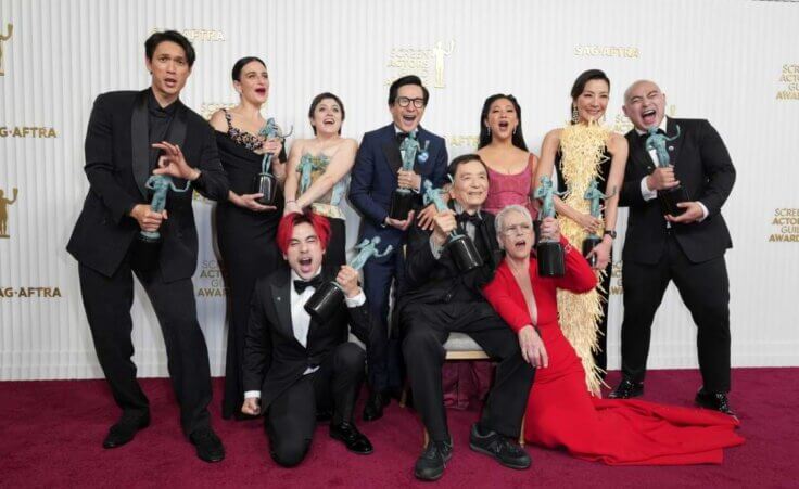 Harry Shum Jr., from back left, Jenny Slate, Tallie Medel, Ke Huy Quan, Stephanie Hsu, Michelle Yeoh, Brian Le, Andy Le, from front left, James Hong, and Jamie Lee Curtis pose with the award for outstanding performance by a cast in a motion pictures for "Everything Everywhere All at Once," in the press room at the 29th annual Screen Actors Guild Awards on Sunday, Feb. 26, 2023, at the Fairmont Century Plaza in Los Angeles. (Photo by Jordan Strauss/Invision/AP). The film is a 2023 Oscar Best Picture nominee.