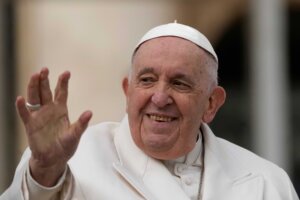 Pope Francis waves to faithful during his weekly general audience in St. Peter's Square.