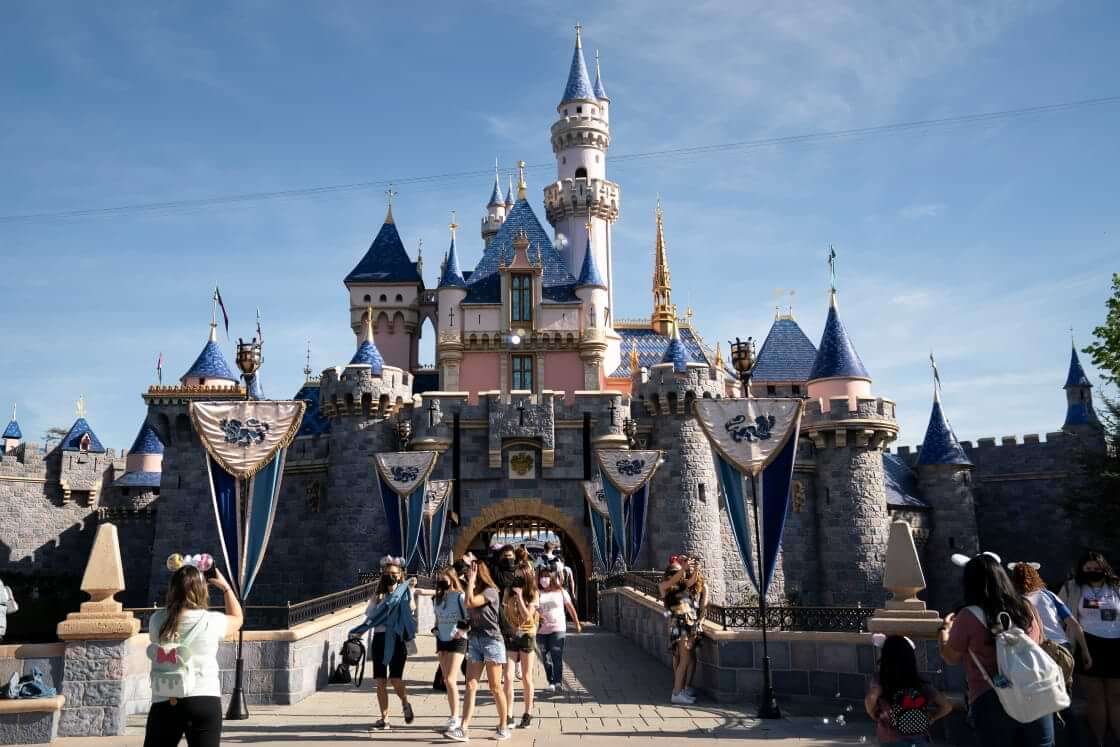 FILE - In this Friday, April 30, 2021, file photo, visitors exit The Sleeping Beauty Castle at Disneyland in Anaheim, Calif. (AP Photo/Jae C. Hong, File). The Walt Disney Company recently announced Pride Nite.