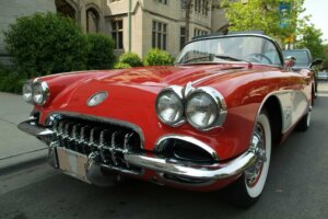 A red corvette sits empty on an urban road. © By chicagophoto/stock.adobe.com