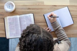 Overhead shot of person journaling while reading their Bible