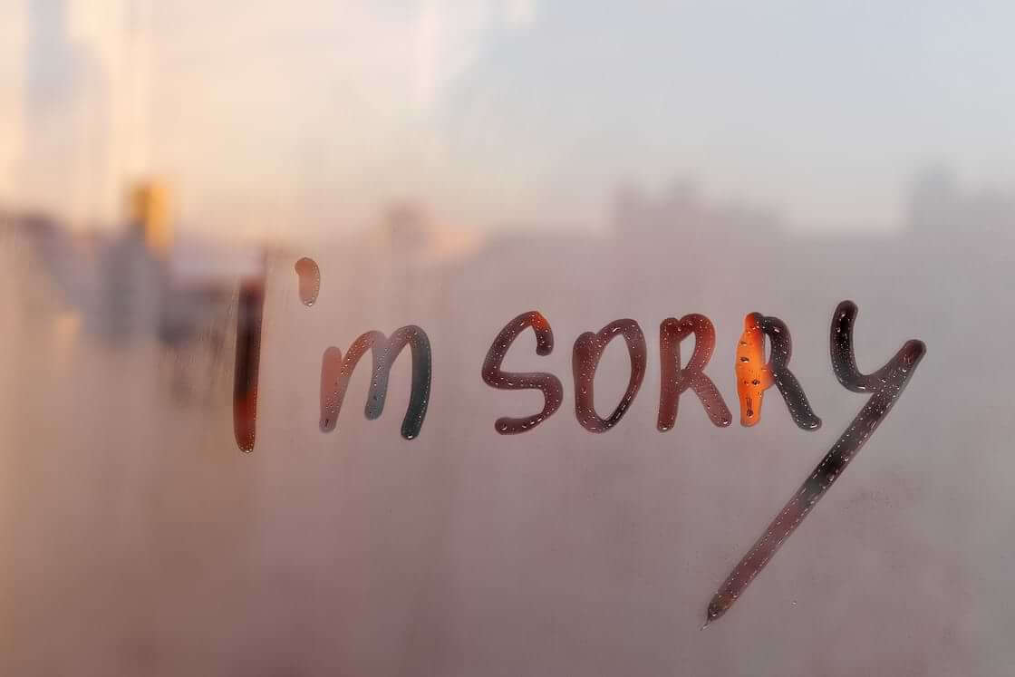 The words "I'm sorry" made onto a foggy window pane.