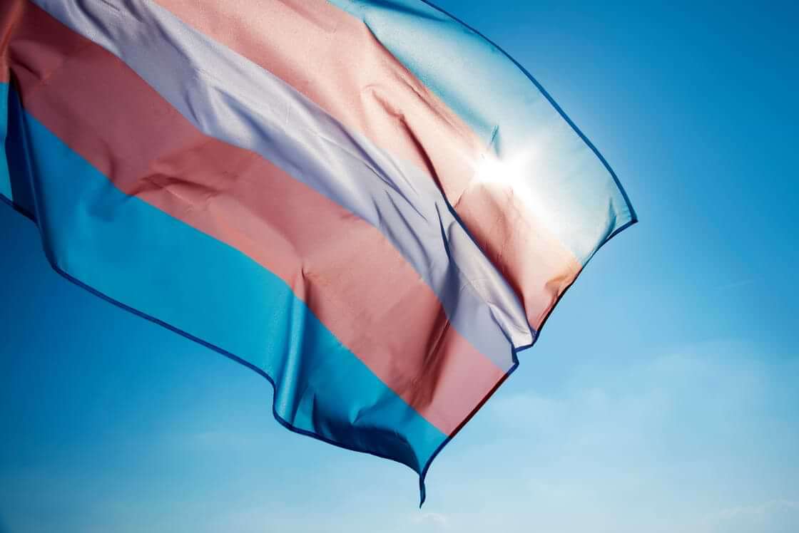 Transgender flag in front of the sun