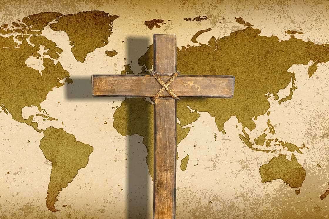 A cross lays atop a world map, a reminder of International Day for the Unreached © By BillionPhotos.com/stock.adobe.com