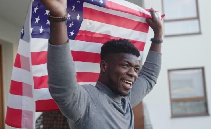 A black man raises an American flag behind and above his head. © By CameraCraft/stock.adobe.com. According to the Smithsonian Institution, “Juneteenth marks our country’s second independence day.”