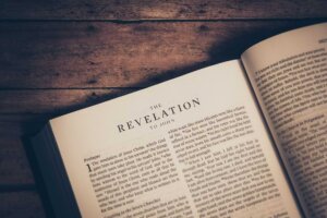 A Bible lays open to the first chapter of Revelation. © By JavierArtPhotography/stock.adobe.com