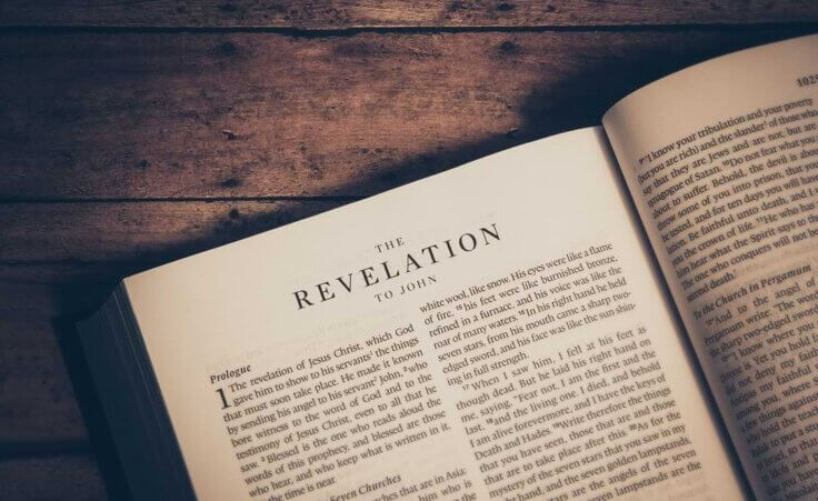 A Bible lays open to the first chapter of Revelation. © By JavierArtPhotography/stock.adobe.com