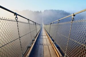 A long and harrowing bridge illustrates "the path to courage" from Russell Moore's book The Courage to Stand. © By mitifoto/stock.adobe.com