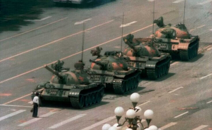 FILE - In this June 5, 1989, file photo, a Chinese man stands alone to block a line of tanks heading east on Beijing's Changan Blvd. in Tiananmen Square. (AP Photo/Jeff Widener, File). The 34th anniversary of the Tiananmen Square massacre was June 4, 2023.