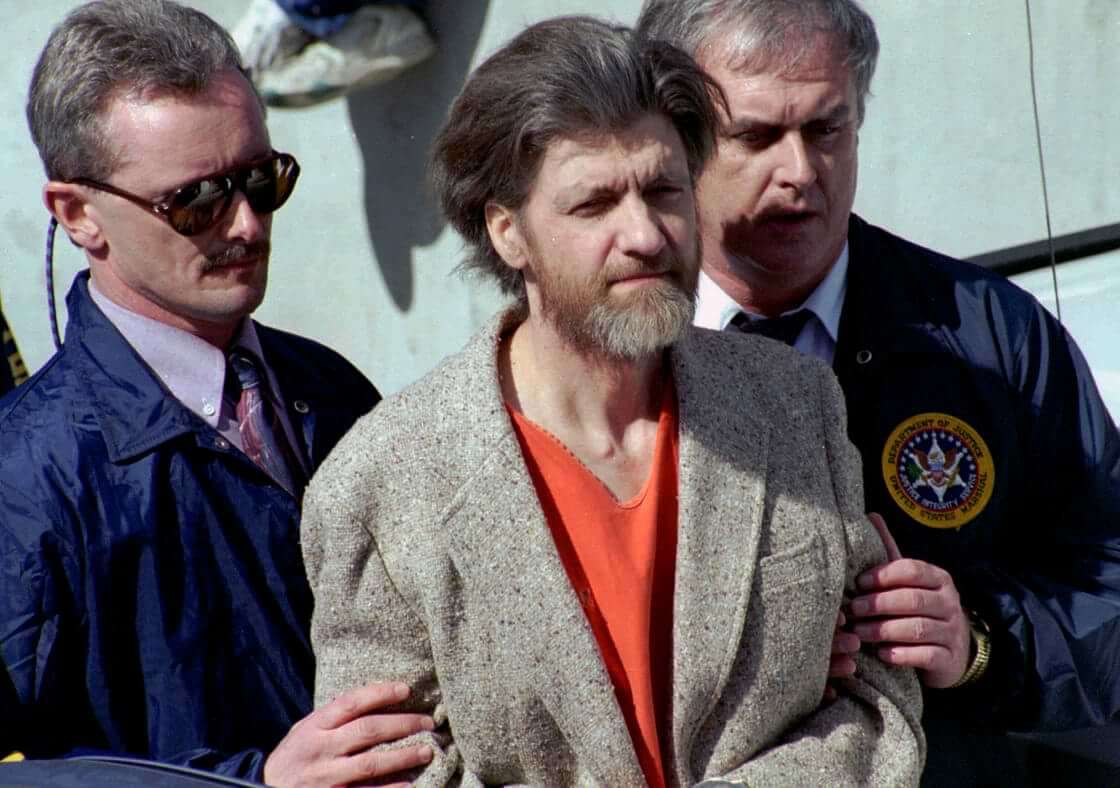 Theodore "Ted" Kaczynski is flanked by federal agents as he is led to a car from the federal courthouse in Helena, Mont., April 4, 1996.