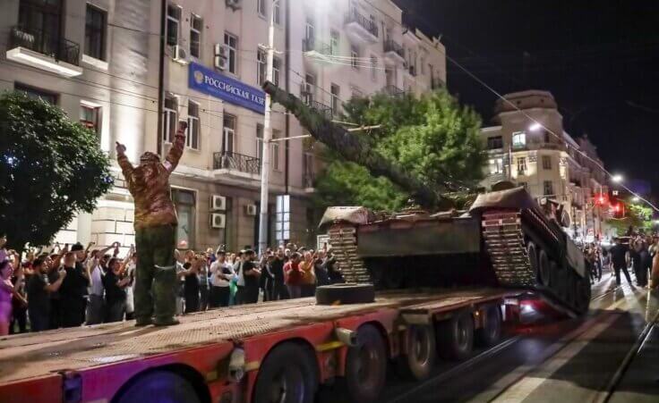 Members of the Wagner Group military company load their tank onto a truck on a street in Rostov-on-Don, Russia, Saturday, June 24, 2023, prior to leaving an area at the headquarters of the Southern Military District.