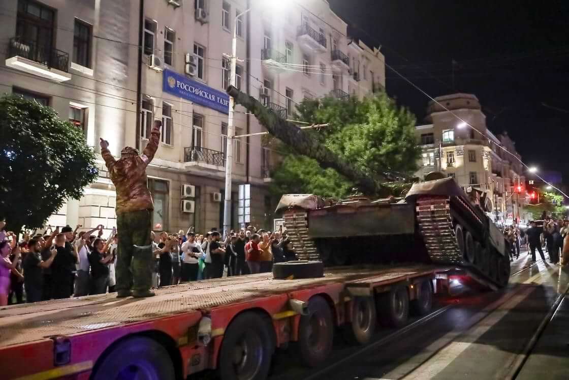 Members of the Wagner Group military company load their tank onto a truck on a street in Rostov-on-Don, Russia, Saturday, June 24, 2023, prior to leaving an area at the headquarters of the Southern Military District.