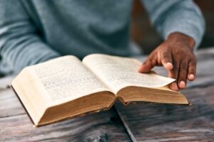 FILE - An African man reads an old Bible, illustrating the fascinating story of a ministry in Chad where Muslims are translating the Bible. © By Katleho Seisa/peopleimages.com/stock.adobe.com