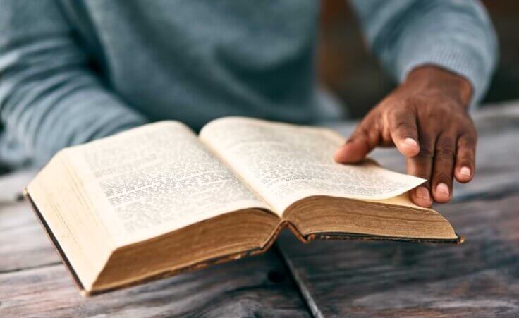 FILE - An African man reads an old Bible, illustrating the fascinating story of a ministry in Chad where Muslims are translating the Bible. © By Katleho Seisa/peopleimages.com/stock.adobe.com