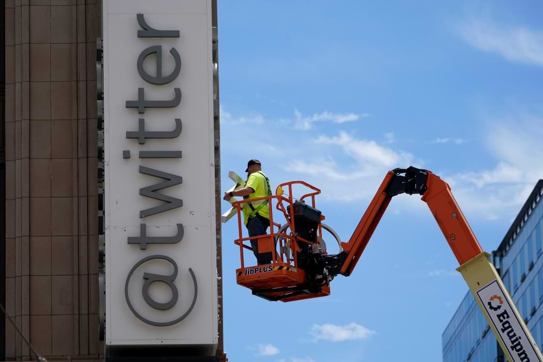 A workman removes a character from a sign on the Twitter headquarters building in San Francisco, Monday, July 24, 2023. Elon Musk has unveiled a new "X" logo to replace Twitter's famous blue bird as he follows through with a major rebranding of the social media platform he bought for $44 billion last year. The X started appearing at the top of the desktop version of Twitter on Monday, but the bird was still dominant across the smartphone app. (AP Photo/Godofredo A. Vásquez)