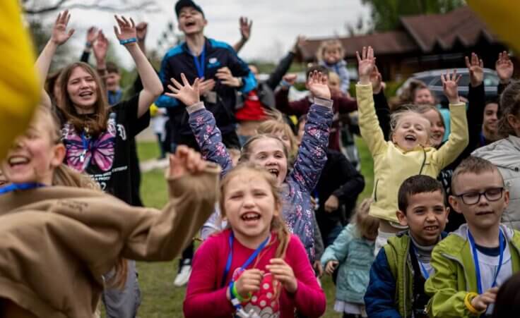 Children dance at the recovery camp for children and their mothers affected by the war near Lviv, Ukraine, Wednesday, May 3, 2023. A generation of Ukrainian children have seen their lives upended by Russia's invasion of their country. Hundreds of kids have been killed. For the survivors, the wide-ranging trauma is certain to leave psychological scars that will follow them into adolescence and adulthood. UNICEF says an estimated 1.5 million Ukrainian children are at risk of mental health issues. (AP Photo/Hanna Arhirova)