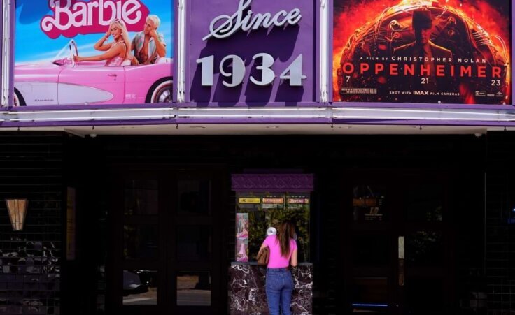 A patron buys a movie ticket underneath a marquee featuring the films "Barbie" and "Oppenheimer" at the Los Feliz Theatre, Friday, July 28, 2023, in Los Angeles. (AP Photo/Chris Pizzello). The simultaneous release resulted in the event called "Barbenheimer."