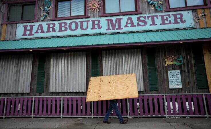 Adam Henderson, owner of Harbour Master Suites, prepares his business ahead of the expected arrival of Hurricane Idalia, Tuesday, Aug. 29, 2023, in Cedar Key, Fla. (AP Photo/Rebecca Blackwell)