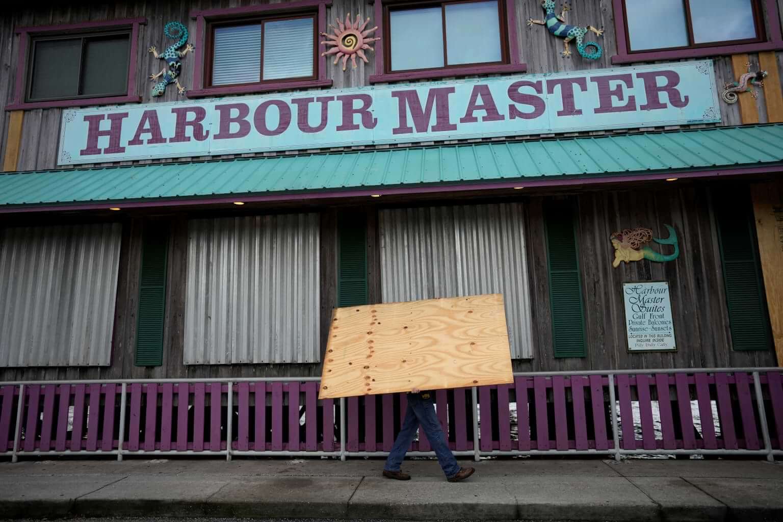 Adam Henderson, owner of Harbour Master Suites, prepares his business ahead of the expected arrival of Hurricane Idalia, Tuesday, Aug. 29, 2023, in Cedar Key, Fla. (AP Photo/Rebecca Blackwell)