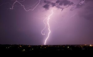 Cloud-to-ground lightning strikes the earth above a country town at night. © By bellass/stock.adobe.com. When the storms of life strike, where do you turn?