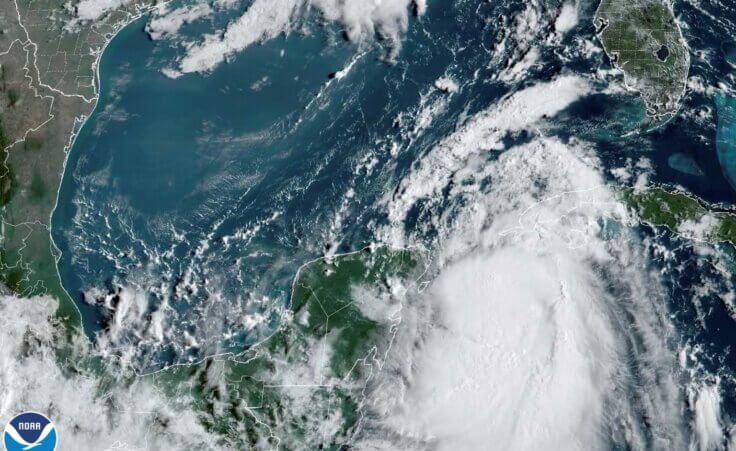 In this Monday, Aug. 28, 2023, 9:41 am ET satellite image provided by the National Oceanic and Atmospheric Administration, Tropical Storm Idalia moves between Mexico's Yucatan peninsula, left, and Cuba, right. Idalia intensified early Monday and was expected to become a major hurricane before it reaches Florida's Gulf coast, according to the National Hurricane Center. (NOAA via AP)