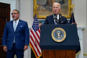 FILE - President Joe Biden speaks in the Roosevelt Room of the White House, June 30, 2023, in Washington, as his administration is moving forward on a new student debt relief plan after the Supreme Court struck down his original initiative. Education Secretary Miguel Cardona listens at left. (AP Photo/Evan Vucci, File)