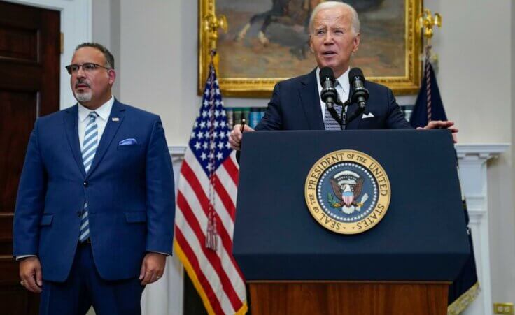 FILE - President Joe Biden speaks in the Roosevelt Room of the White House, June 30, 2023, in Washington, as his administration is moving forward on a new student debt relief plan after the Supreme Court struck down his original initiative. Education Secretary Miguel Cardona listens at left. (AP Photo/Evan Vucci, File)