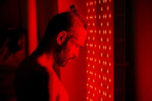 STOCK PHOTO: A man stands in front of an infrared light system similar to what Bryan Johnson uses as part of his "Blueprint" system to attempt to live forever. By Shawn M. Pridgen/stock.adobe.com.