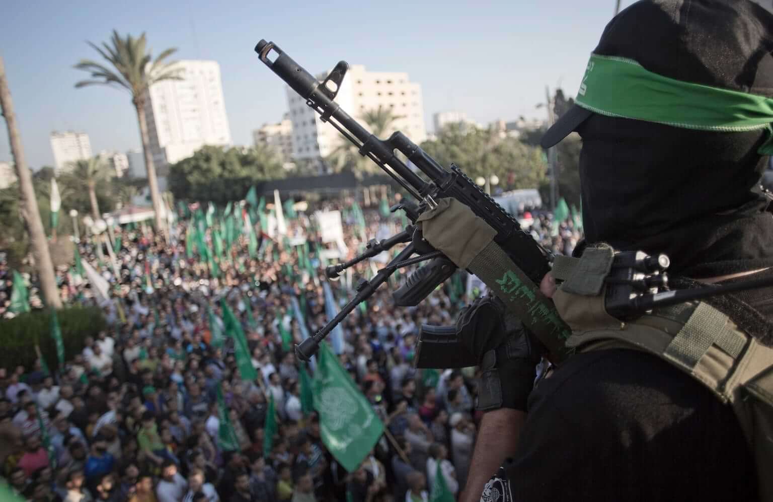 A Palestinian masked Hamas gunmen holds his rifle as he guards during a rally in Gaza City, Wednesday, Aug. 27, 2014. (AP Photo/Khalil Hamra)