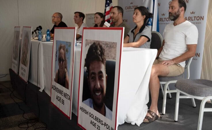 FILE - Relatives of U.S. citizens that are missing since Saturday's surprise attack by Hamas militants near the Gaza border, attend a news conference on Oct. 10, 2023 in Tel Aviv, Israel. Seated from left: Jonathan Dekel-Chen, father of Sagui Dekel-Chen (35) from Nahal Oz; Ruby Chen, father of Itay Chen, 19, a soldier in the armored corps; Ayala Neta, daughter, and Nahal Neta, son of Adrienne Neta, 66, a nurse living in Kibbitz Be'eri; Rachel Goldberg, mother of Hersh Goldberg-Polin, 23, and Jonathan Polin, Hersh's father. Hersh was last seen when Hamas militants loaded him into the back of a pickup truck with other hostages abducted from a trance music festival in the western Negev Desert on Oct. 7. His mother, Rachel Goldberg, expects to see him again. (AP Photo/Maya Alleruzzo, File)
